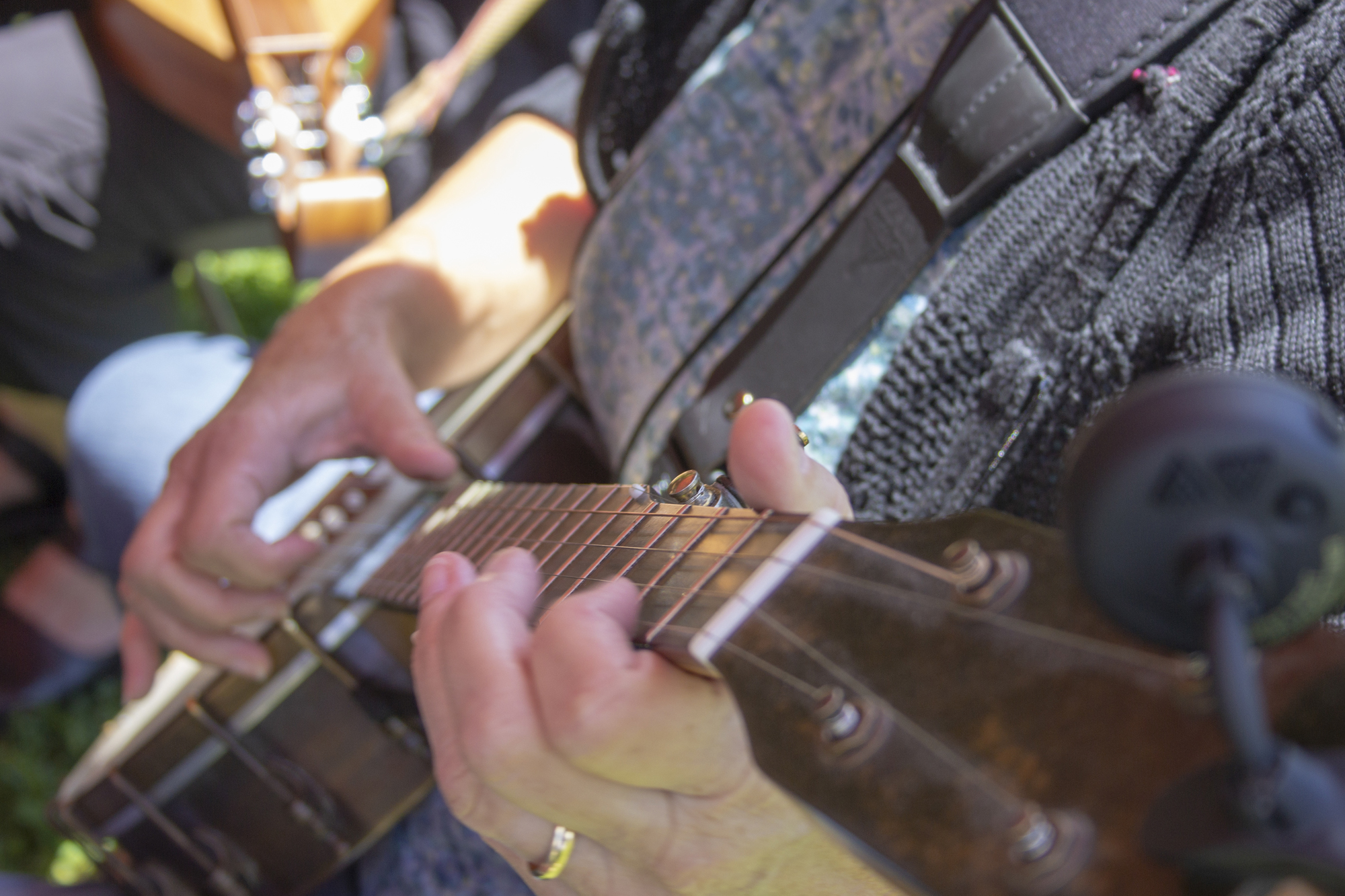 close-up of hands playing a guitar