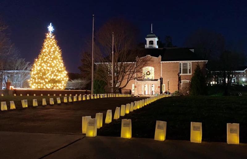 Luminaries line the sidewalk in front of Marshbanks Hall.