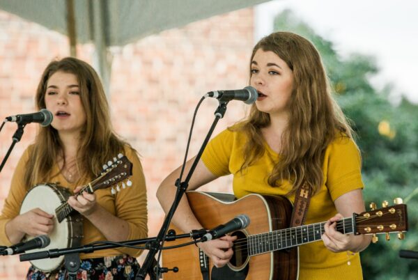 two young women playing banjo and guitar