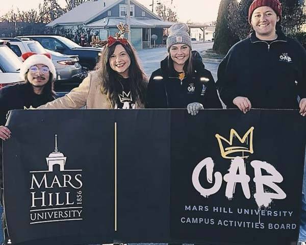 students and Brooklyn holding Campus Activities Board banner