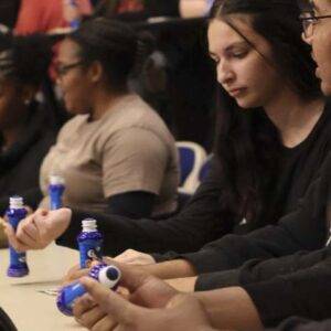 Students playing bingo, holding markers